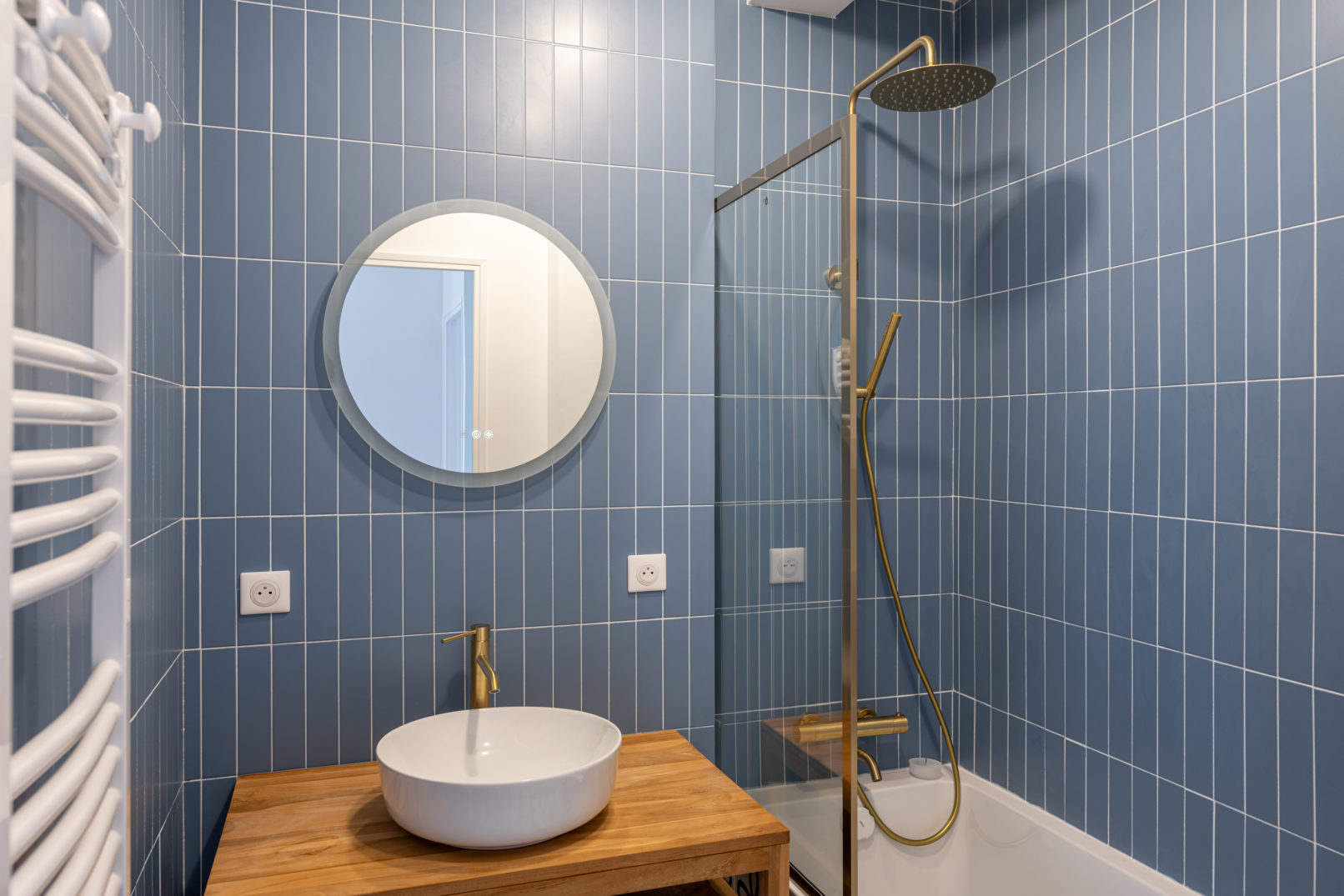 Salle de bain avec faïence bleu et meuble en teck